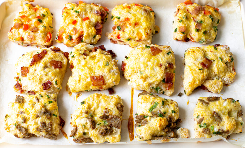Baked breakfast biscuits on a baking sheet.