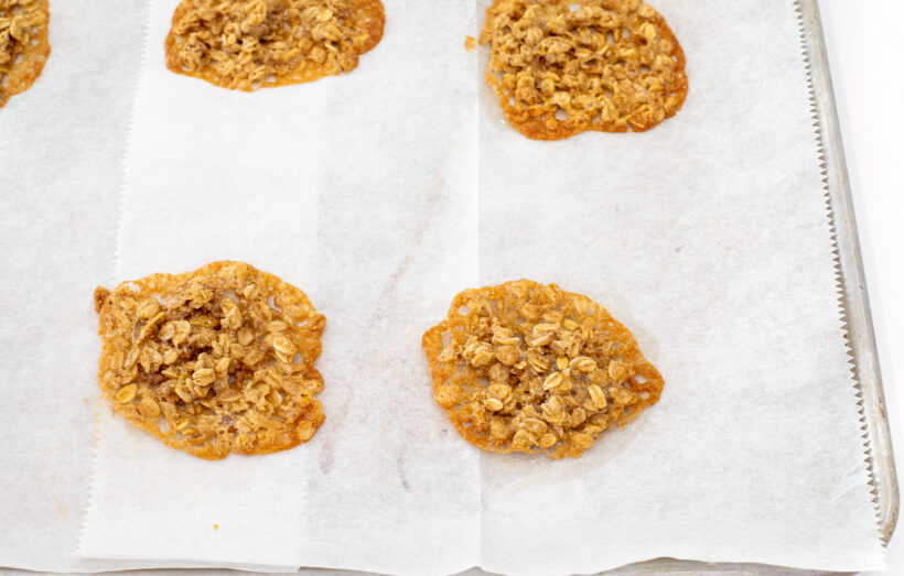 Lace cookies on a baking sheet with parchment paper. 