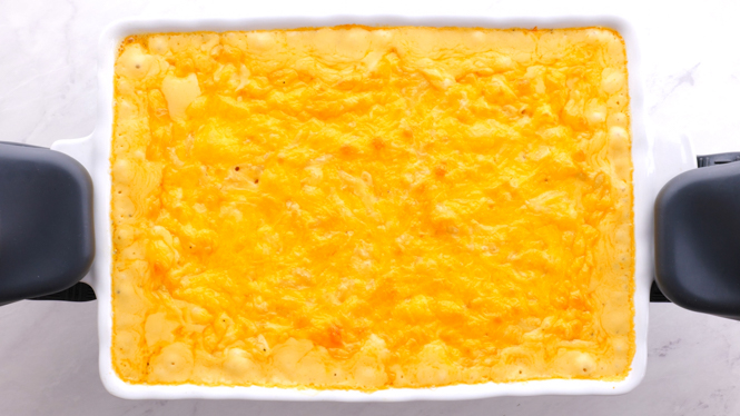 removing baked macaroni and cheese from the oven