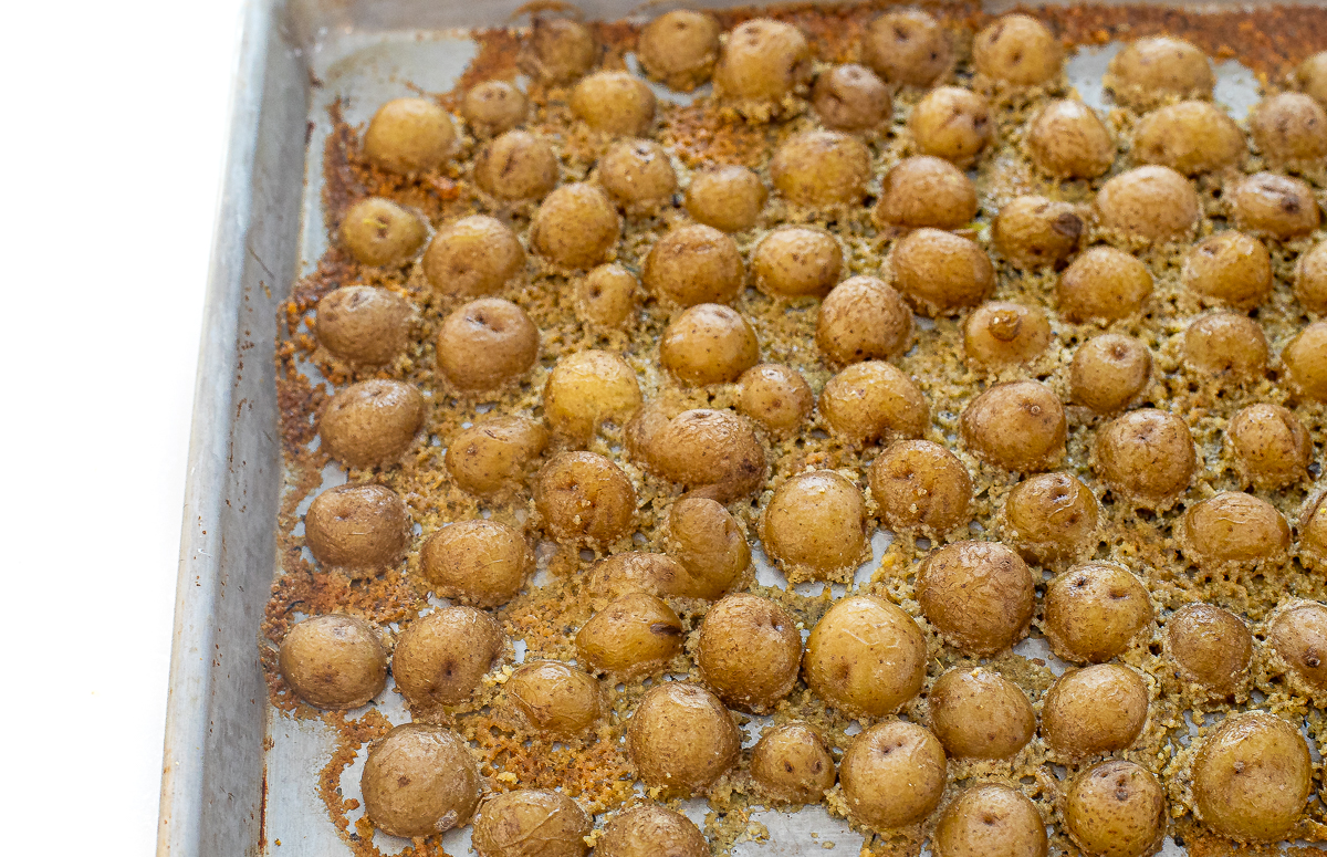 Potatoes in the parmesan butter after being baked. 