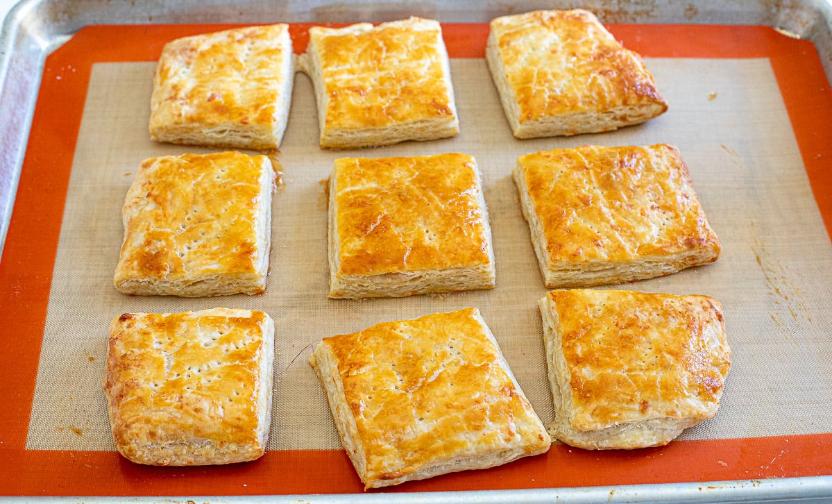 baked puff pastry squares on baking sheet lined with a silicone baking mat