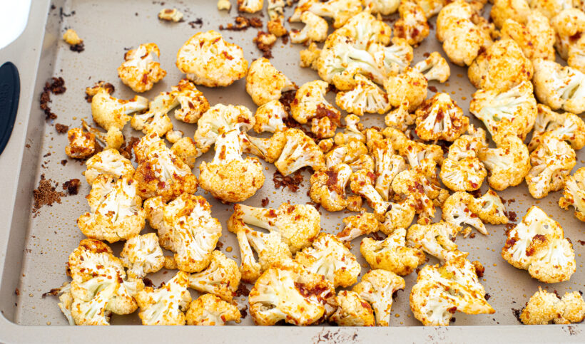 Harissa cauliflower on a sheet pan after being baked.