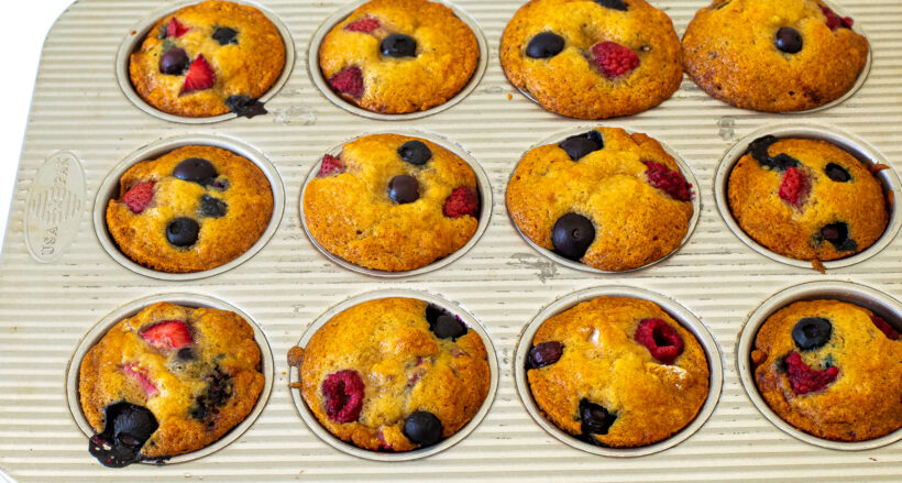 Muffins in the muffin tin after being baked.