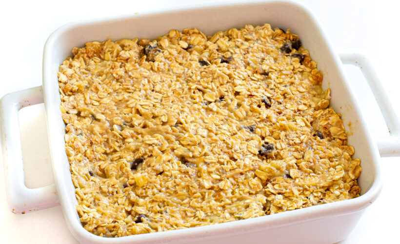 Oat bar mixture pressed into a baking dish before being baked.