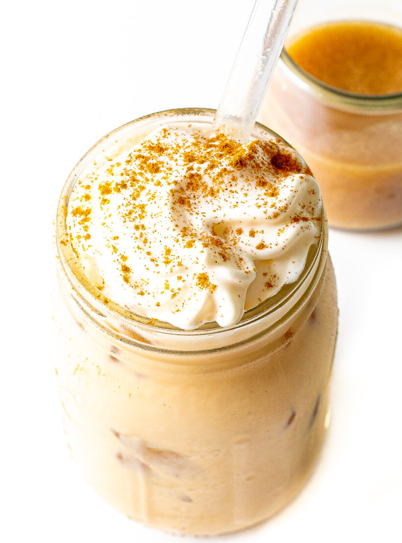Banana bread latte in a glass jar with a clear straw.