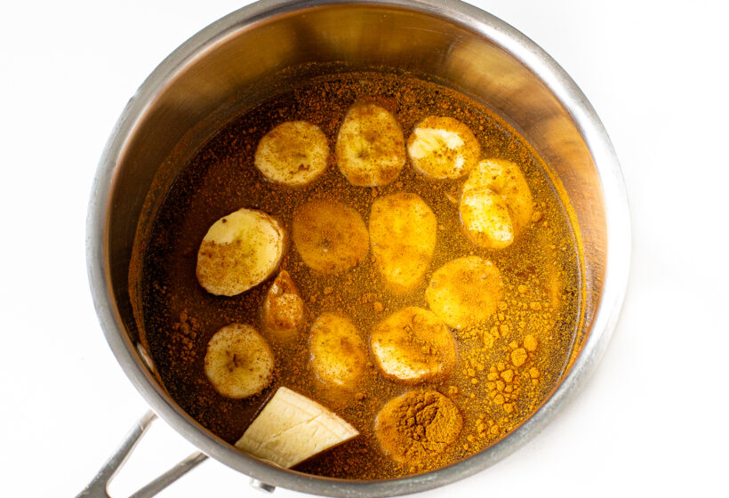 Banana bread syrup simmering in a saucepan on the stove.