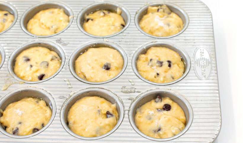 Muffin batter in a muffin tin.