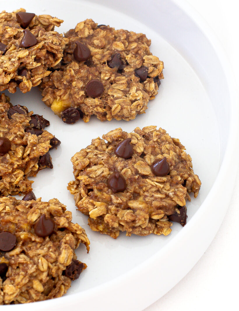 Banana oat cookies lined up on a large white plate. 