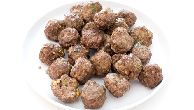 browned baked meatballs on white plate