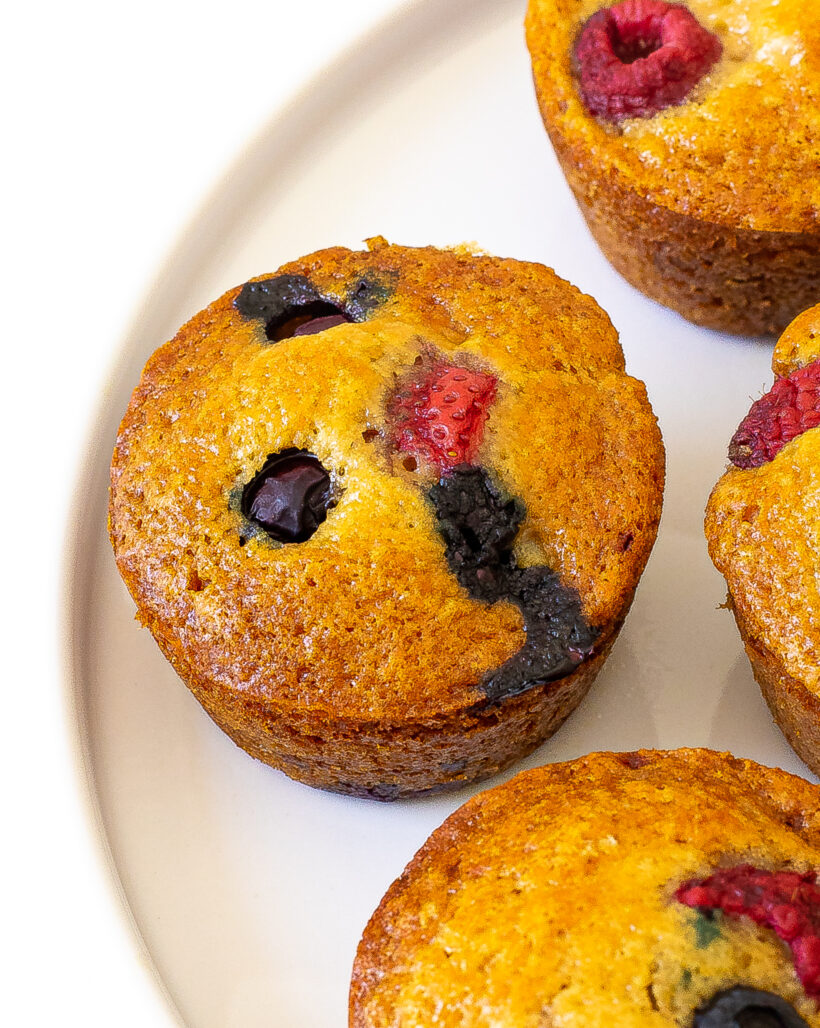 Close up shot of berry muffin on a plate.