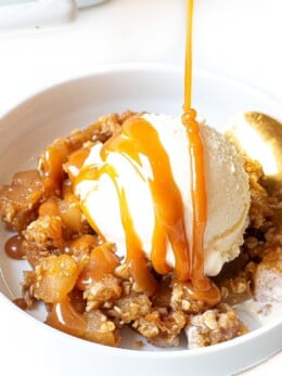 Drizzling caramel over ice cream and apple crisp.