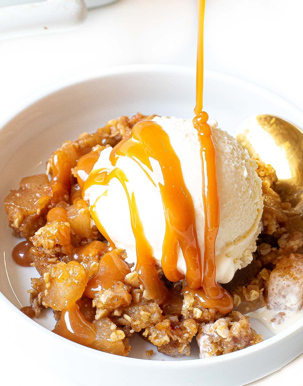 Drizzling caramel over ice cream and apple crisp.