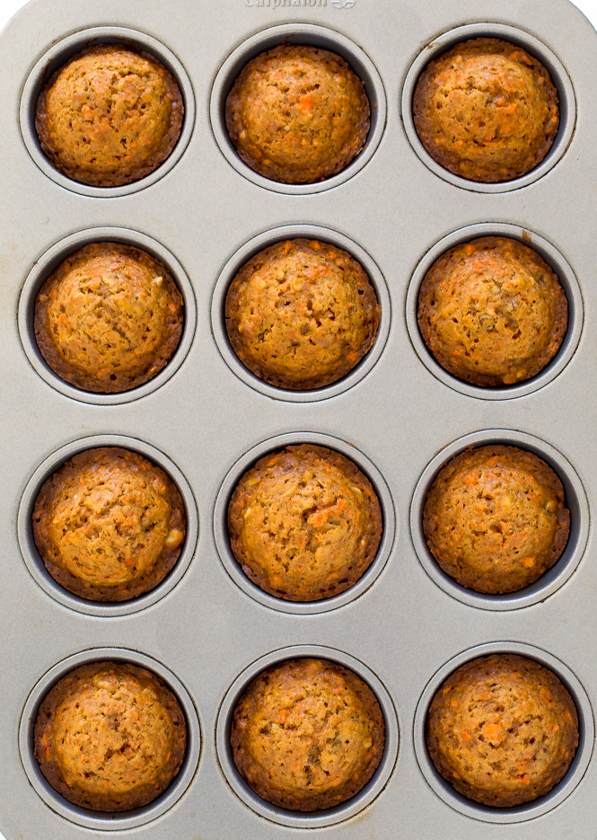 overhead shot of healthy carrot cake muffins in silver muffin tin