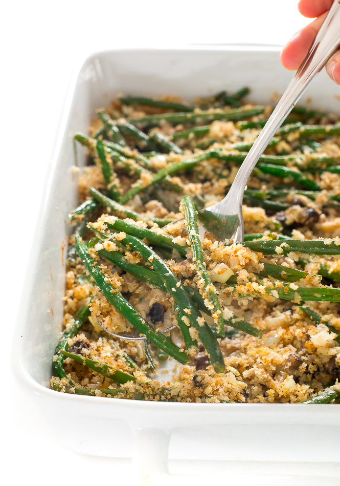 scooping up lightened up green bean casserole with a large silver spoon