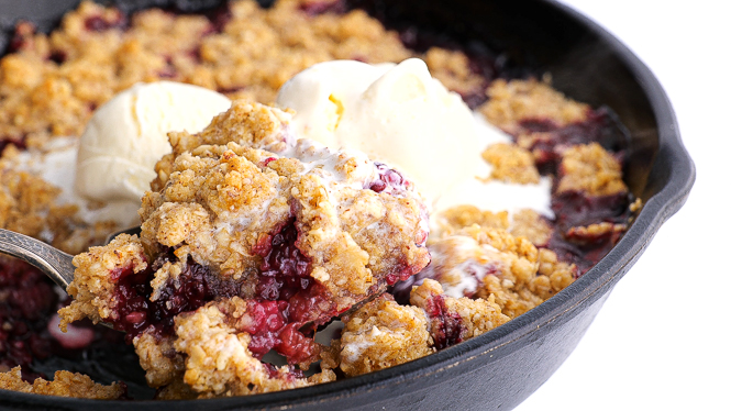 serving blackberry crisp with vanilla ice cream