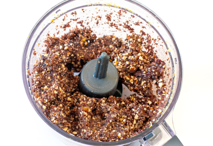 Ingredients for energy bites in the food processor after being blended. 