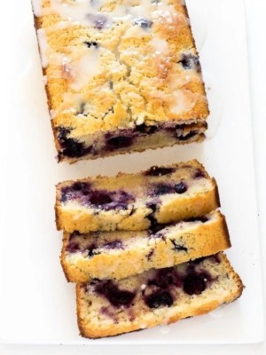 sliced lemon blueberry bread with a glaze