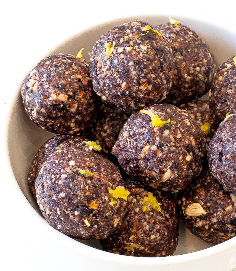 Blueberry energy balls served in a white serving bowl. 