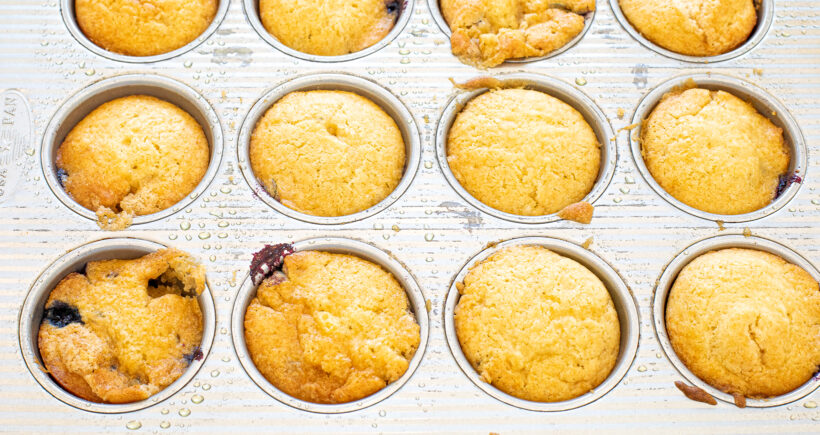 Blueberry mini cakes in the muffin tin after being baked. 