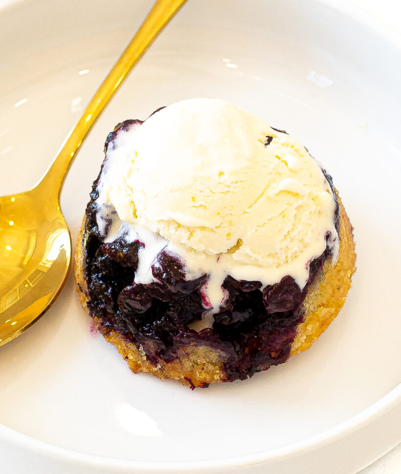 Mini blueberry cake served with a scoop of ice cream on top. 