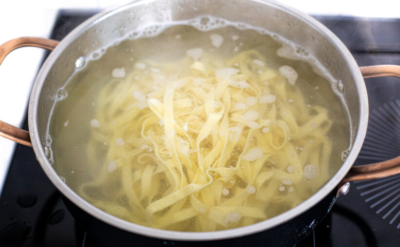 Boiling homemade pasta in a large pot.