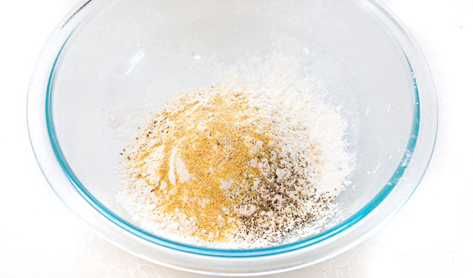 Cornstarch breading mixture in a glass mixing bowl. 