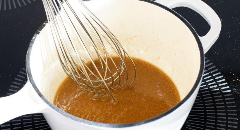 Butter and brown sugar being melted on the stove top.