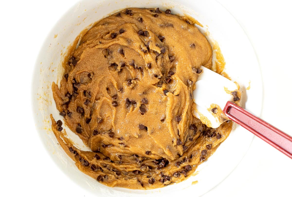 folding chocolate chips into brown butter cookie dough batter