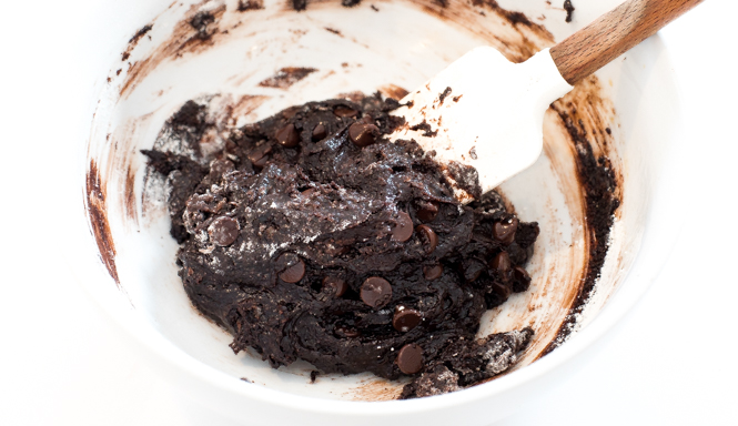 white bowl with brownie batter mixed together