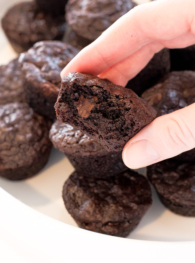 the author holding up one of these Homemade Brownie Bites with a bite taken out
