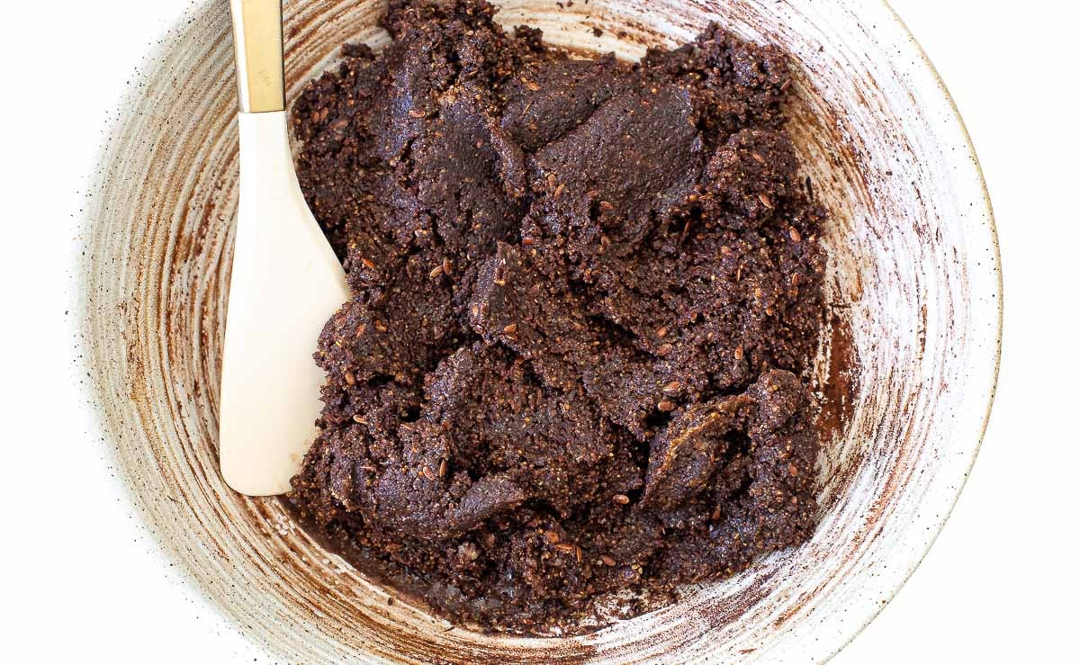 mixing ingredients for brownie energy bites in bowl