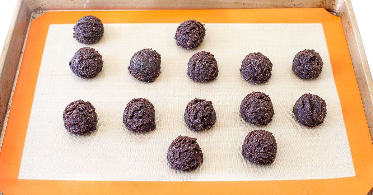 rolled chocolate energy balls on baking sheet