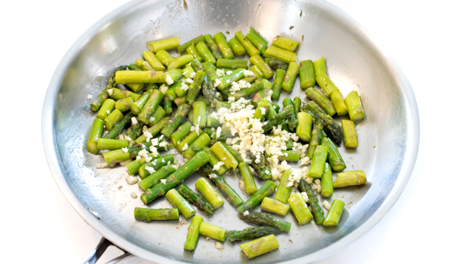 chopped asparagus and minced garlic sautéed in a skillet