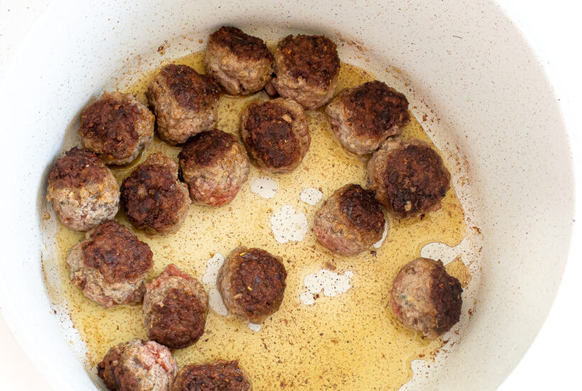 browning beef meatballs in large pot