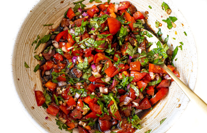 bruschetta mixed together in bowl with spoon