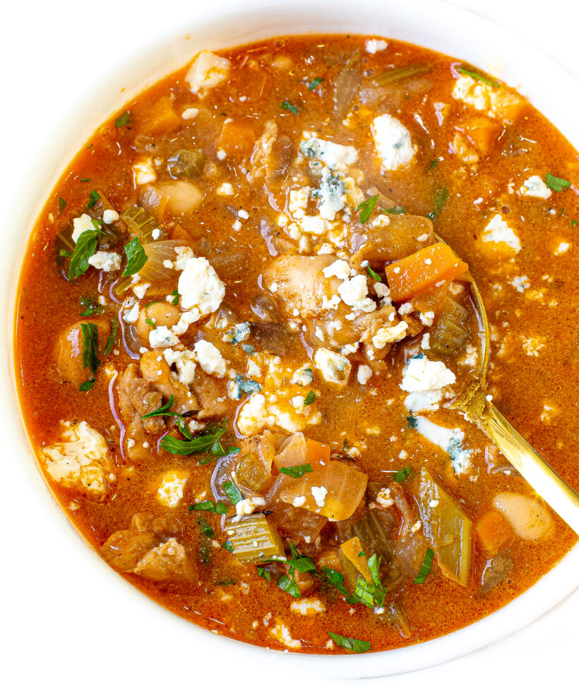 Buffalo Chicken Chili in a white bowl with gold spoon.