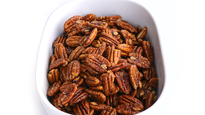 candied nuts in a white casserole dish
