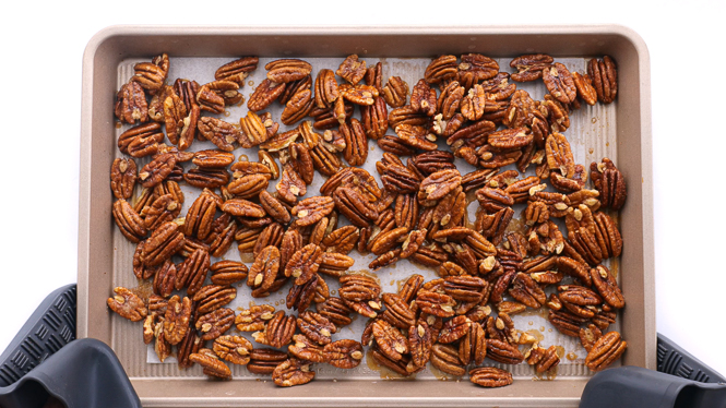 removing candied pecans from the oven