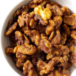 Candied walnuts in a white bowl.