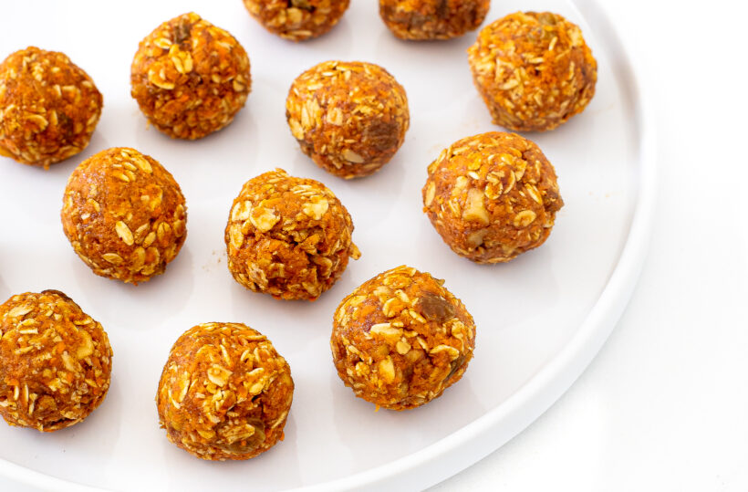 Carrot cake oat balls on a plate.