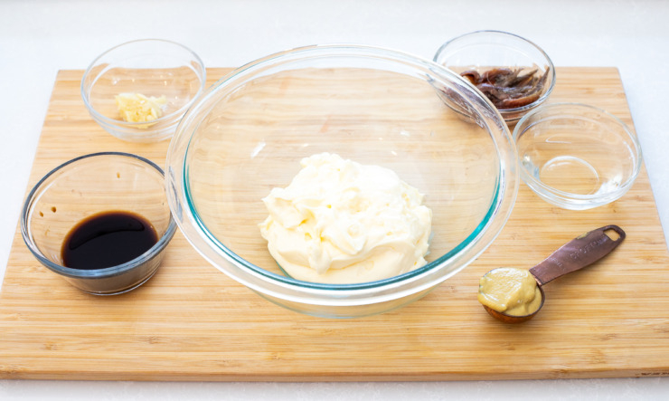 Ingredients needed for homemade caesar dressing.