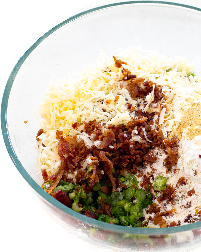 bacon, cheese, flour, green onions and seasonings in large clear bowl