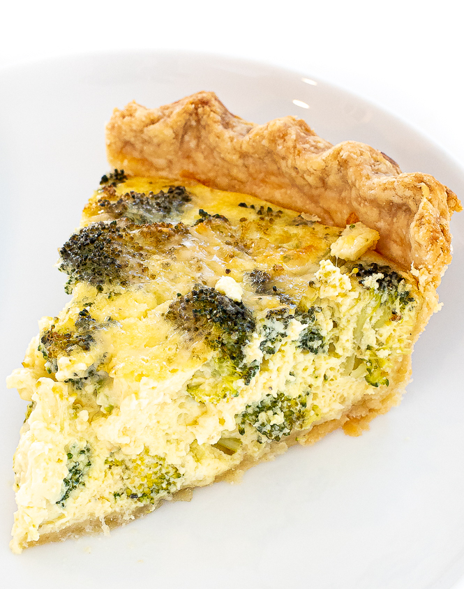 slice of cheddar broccoli quiche on small white plate