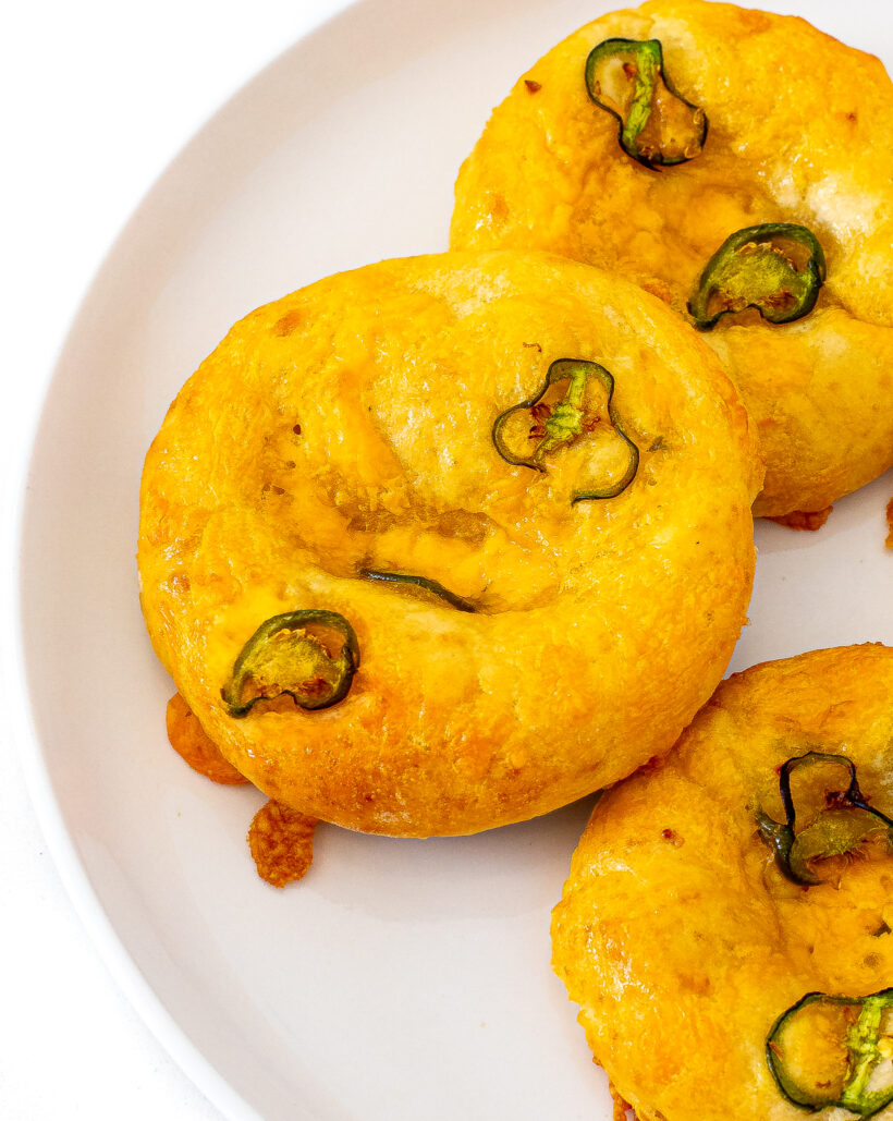 Jalapeno bagels on a white plate.