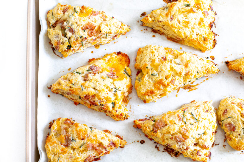 Ham and cheese scones on a baking sheet after being baked. 