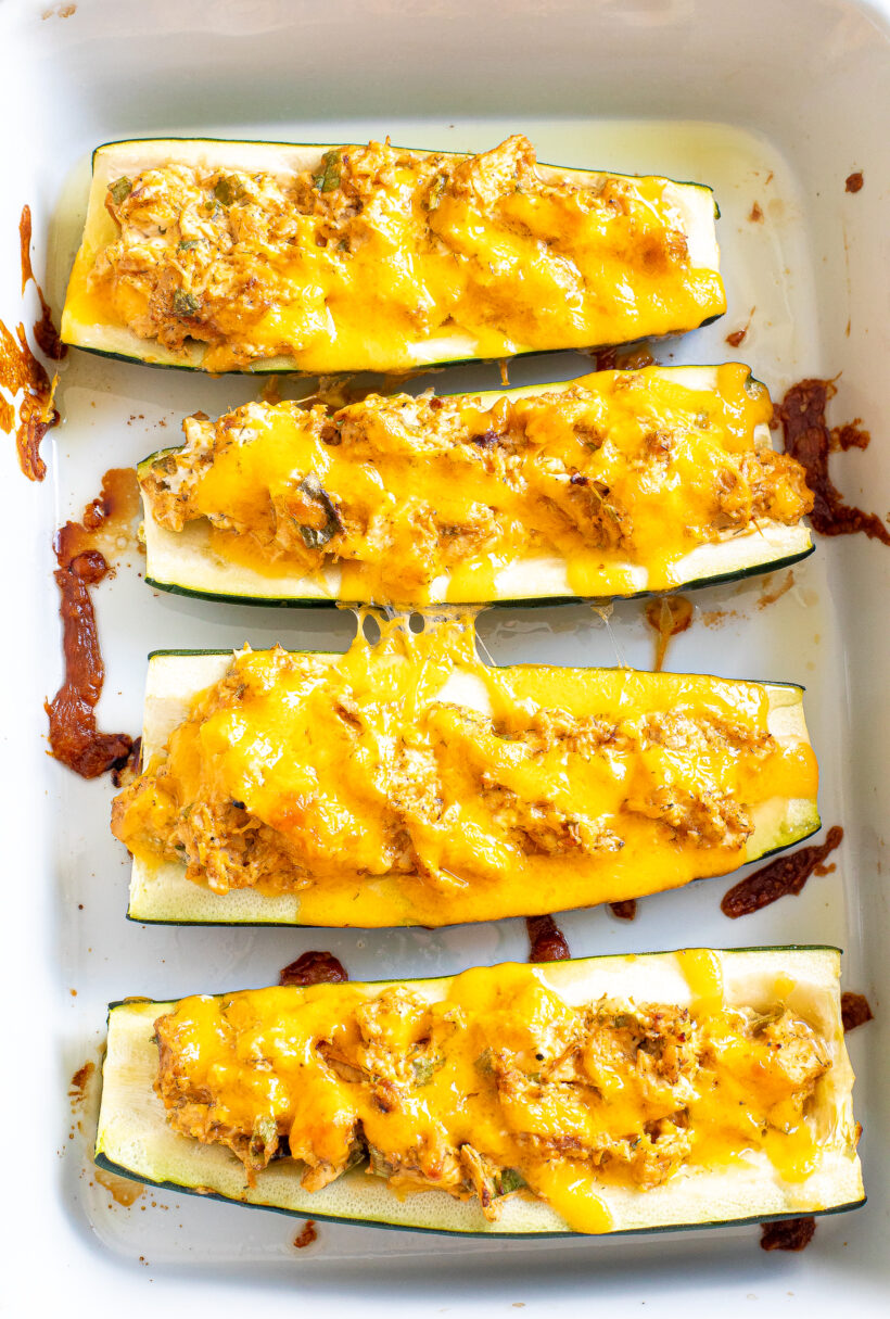 Zucchini boats in the baking dish after being baked.