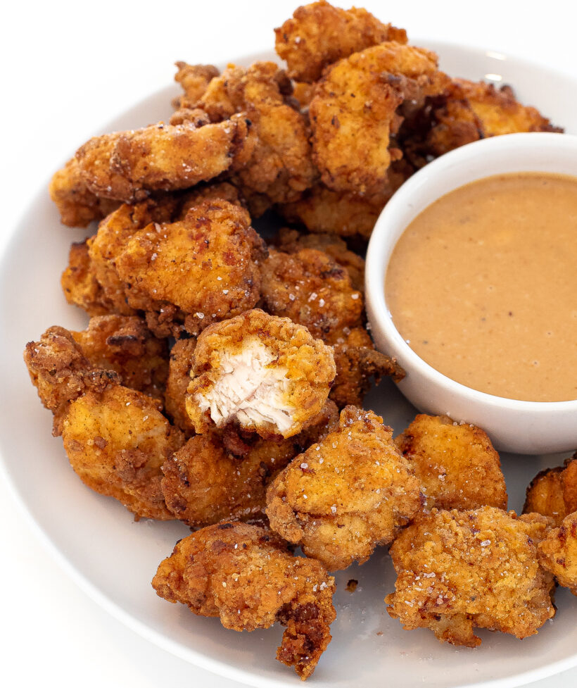 Chicken nuggets with one nugget missing a bite.