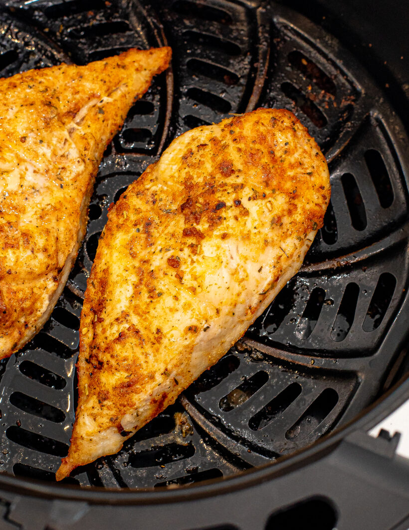 Overhead shot of air fryer chicken in the air fryer basket.