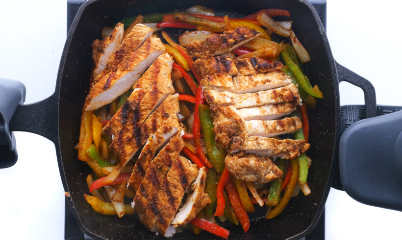 adding sliced chicken fajitas back to the skillet