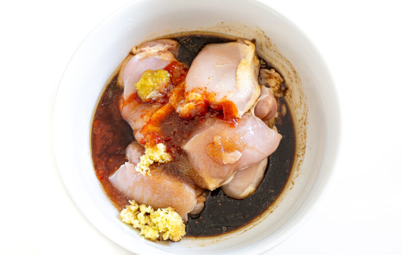 overhead shot of chicken thighs marinating in Thai marinade